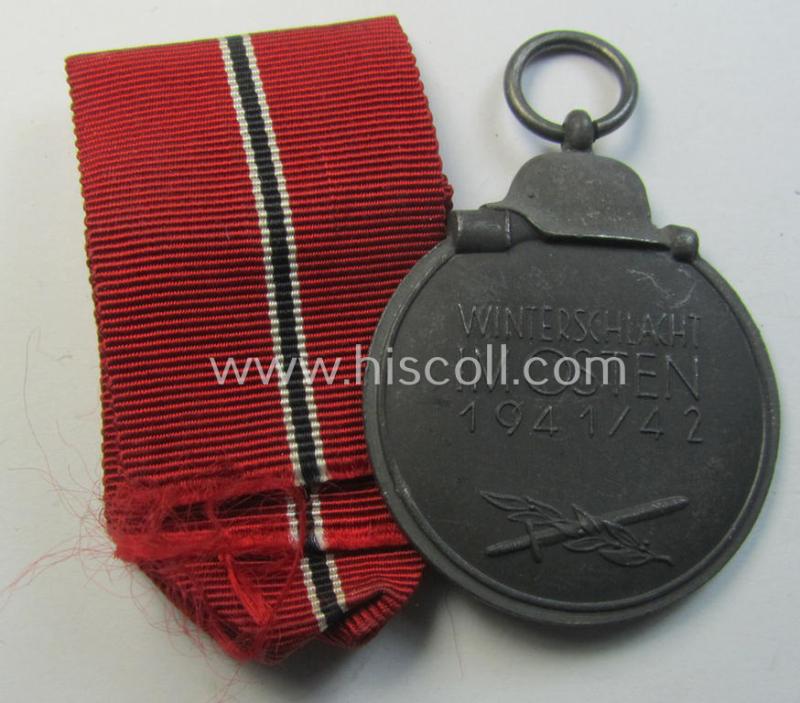 Neat medal-set: 'Winterschlacht im Osten 1941-42' being a non-maker-marked- (and/or typical 'Feinzink'-based) specimen that comes together with its (minimally confectioned) ribbon (ie. 'Bandabschnitt')