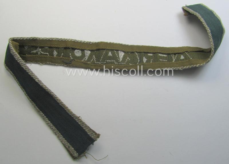 Truly worn, 'BeVo'-like cuff-title (ie. 'Ärmelstreifen') entitled: 'Afrikakorps' being a with certainty issued example that comes in an overall nice- (ie. somewhat shortened- and/or once tunic-attached-), condition