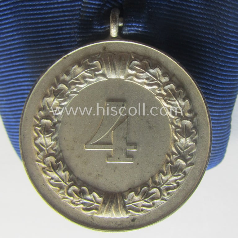 Silver-toned, WH (Heeres o. KM) so-called: 'Einzelspange' showing a: 'WH-Dienstauszeichnung 4. Stufe' (as was intended for 4 years of loyal-service) and that shows a detailed, Heeres o. KM-type-eagle-device, period-attached