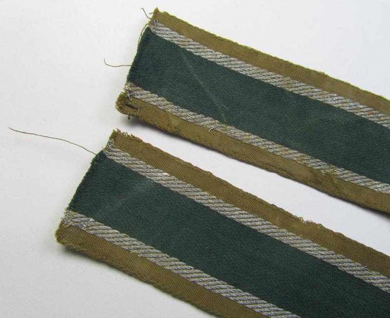 Attractive, 'BeVo'-like cuff-title (ie. 'Ärmelstreifen') entitled: 'Afrikakorps' being a with certainty issued and truly worn example that comes in an overall nice- (ie. minimally shortened- and once tunic-attached-), condition