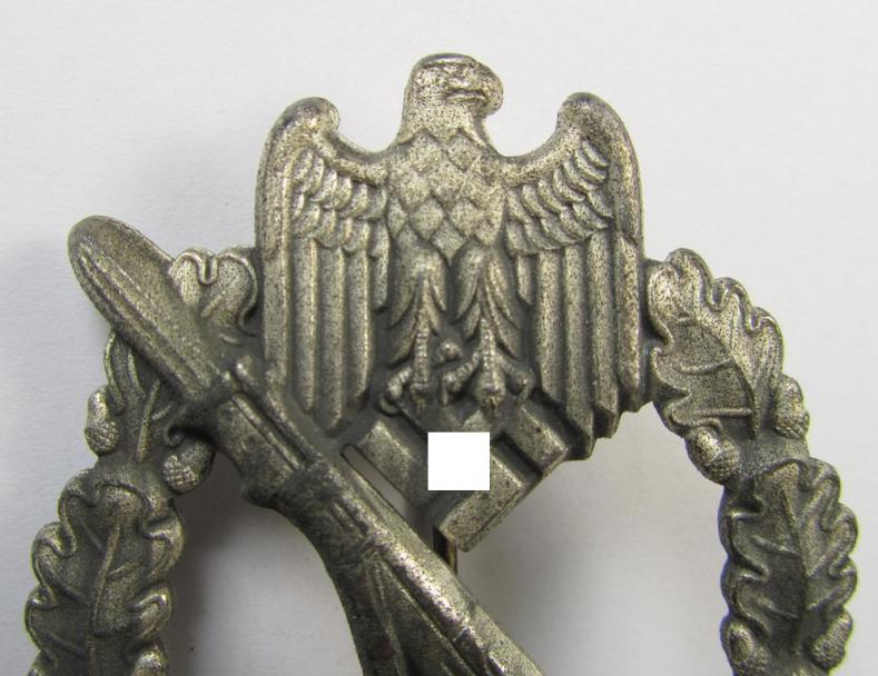 'Infanterie-Sturmabzeichen in Silber' being a non-maker-marked- and/or zinc- (ie. 'Feinzink'-) based specimen of the so-called: 'egg-head'-pattern (as was presumably produced by the 'Hersteller' ie. maker: 'Gustav Brehmer')