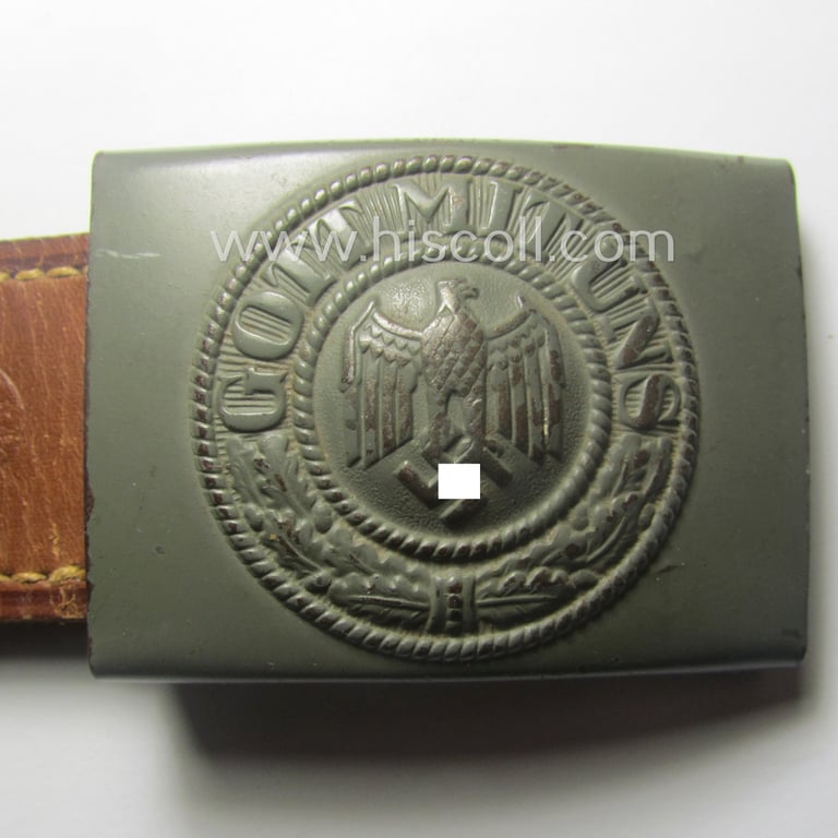 WH (Heeres) 'standard-pattern', field-grey-toned- and steel-based belt-buckle being a maker- (ie. 'Berg u. Nolte - Lüdenscheid'-) marked- and/or: '1942'-dated example that comes mounted onto its leather-based tab
