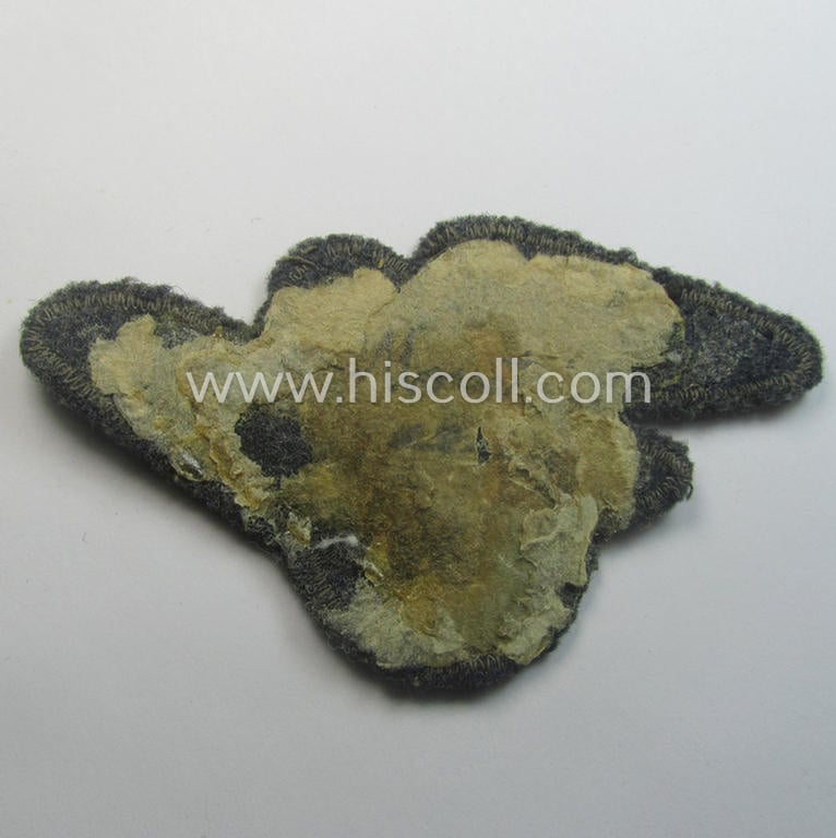 Moderately used, officers'-pattern, 'Luftschutz' (ie. RLB-) breasteagle being a neatly 'BeVo'-flat-wire'-woven example that is executed onto a bluish-grey-coloured- and/or woolen-based background