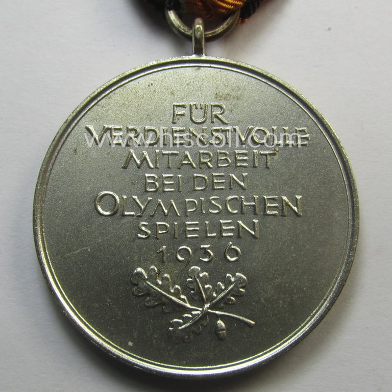 Superb, 'Deutsche Olympia-Erinnerungsmedaille 1936' being a non-maker-marked example that comes mounted onto its original ribbon (ie. 'Bandabschnitt') and that comes stored in its typical, beige-white-coloured etui