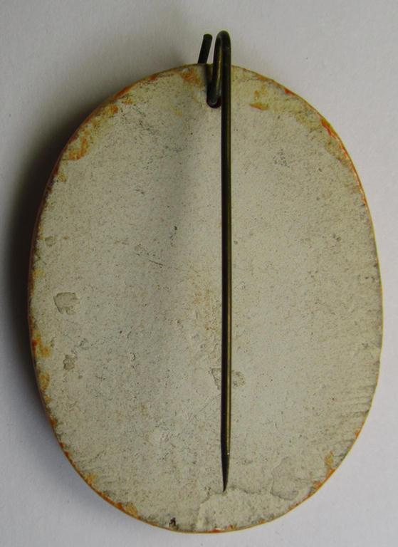 Dutch NSB-party-related, so-called: 'Hagespraak'-lapel-pin (ie. 'Veranstaltungsabzeichen' ie. tinnie) that is executed in orange-toned, ceramic-based material and that is depicting the text: 'Hagespraak - Lunteren 1938'