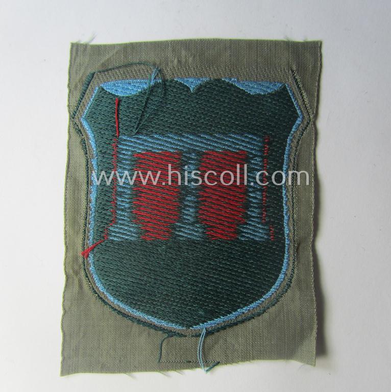 Eastern- (ie. Russian-) volunteer related armshield as executed in 'BeVo'-weave pattern depicting a red-coloured 'Tamga'-symbol as was intended for a volunteer who served within the 'Deutsche Wehrmacht' (ie. within the 'Crimean-Tartar Legion'...