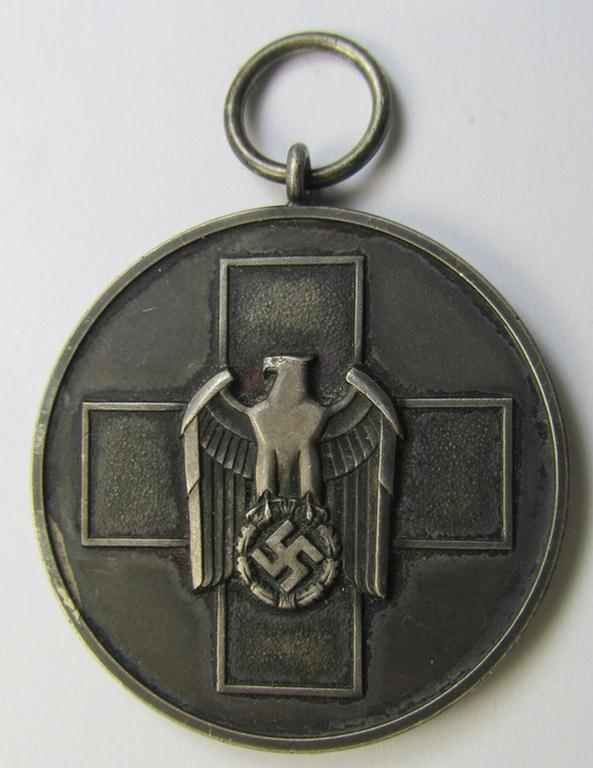Attractive, silver-toned (and I deem 'Buntmetall'-based!) 'Deutsche Volkspflege'- (ie. civil-service) medal being a non-maker-marked example that came together with its (confectioned- and somewhat shortened) ribbon (ie. 'Bandabschnitt')