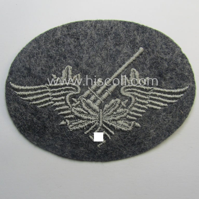 Machine-embroidered WH (Luftwaffe) trade- ie. special-career-patch as was intended for: 'Flak-Artillerie'-staffmembers and that comes in a probably issued but never worn- (ie. 'virtually mint'-), condition