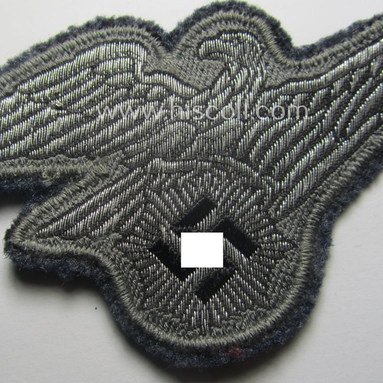 Minimally used, officers'-pattern, 'Luftschutz' (ie. RLB-) breasteagle being a neatly 'BeVo'-flat-wire'-woven example that is executed onto a bluish-coloured- and/or woolen-based background