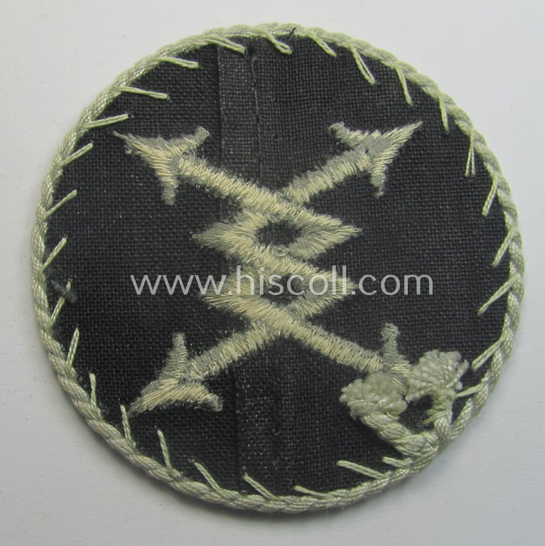 WH (Luftwaffe) machine-embroidered, trade- ie. special-career-patch (ie. 'Tätigkeitsabzeichen') having a silver-white-toned 'Kordel' attached as was intended for: 'LW-Fernsprech'-staffmembers