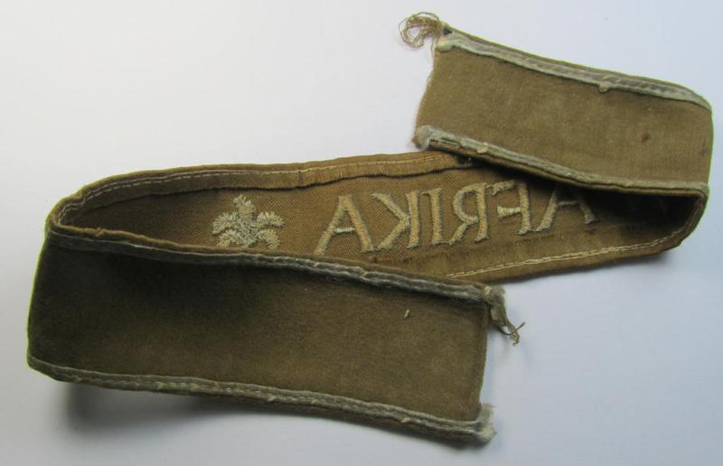 Attractive, WH (LW o. Heeres) cuff-title (ie. 'Ärmelstreifen') entitled: 'Afrika' (being a period-shortened- and woolen-based example that comes in a clearly issued- and/or worn condition)