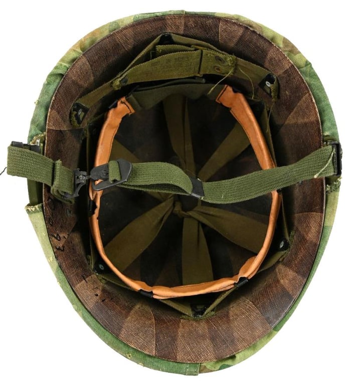US Vietnam War Infantry helmet with camouflage cover and attached content