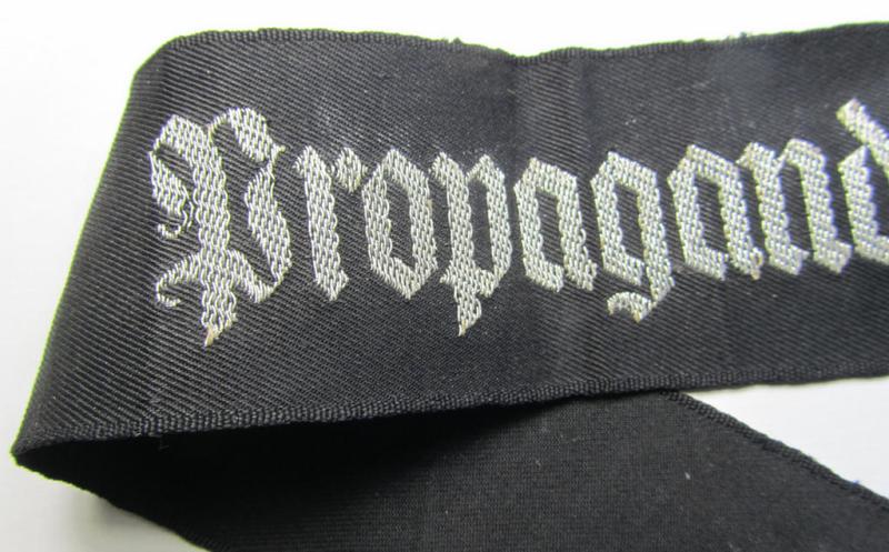 Superb - and most certainly rarely seen! - WH (Heeres) related cuff-title (ie. 'Ärmelstreifen') being a typical black-coloured- and linnen-based example showing the (neatly silver-toned- and 'flatwire'-woven!) text that reads: 'Propagandakompani...