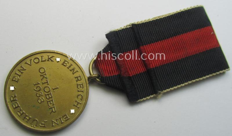 WH Czech-occupation- (ie. 'Anschluss'-) medal: '1. Oktober 1938' being a neat (albeit minimally tarnished) example that comes mounted onto its period ribbon and that shows a firmly (and period!) attached 'Prager Burg-Spange'
