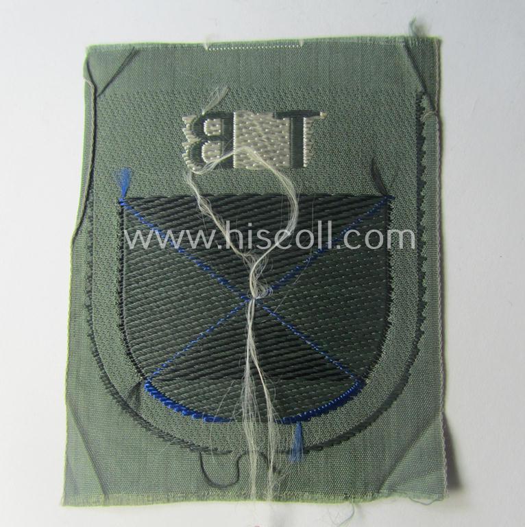 Eastern- ie. Russian volunteer (ie. Cossack-) related armshield as executed in the neat 'BeVo'-weave pattern depicting the interwoven 'Cyrillic' characters: 'TB' (as was intended for the Russian volunteers serving within the 'Terek Cossacks')