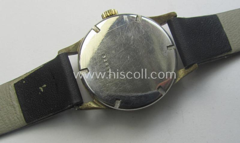WH (Kriegsmarine) WWII-period wrist-watch (or: 'Dienstuhr') of the make: 'K.M. - 592' having a beige-white-coloured dial-plate and neatly engraved number on its back that reads: '328721'