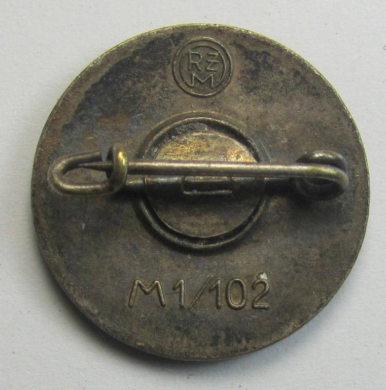 Attractive - darker-red-coloured and nicely preserved! - 'N.S.D.A.P.'-membership-pin- ie. party-badge (or: 'Parteiabzeichen') which is maker-marked on the back with the makers'-designation: 'RzM' and/or: 'M1/102'