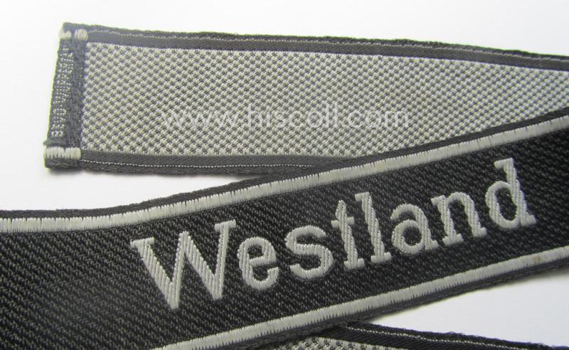 Waffen-SS, 1943/44 pattern cuff-title (ie. 'Ärmelstreifen') depicting the machine-woven Latin script text in silver-grey linnen as was intended for a member of the: 'SS-Regiment': "Westland" (ie. part of the: '5. SS-Pz-Gren.-Div. "Wiking")