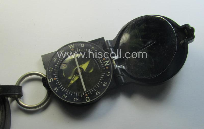 Pre-war-period, 'standard-issued'-pattern, black-coloured and resin-based WH compass (ie. 'Marschkompass') which is nicely maker- (ie. 'Busch - Rathenow'-) marked and that comes stored in its specific, leather-based etui