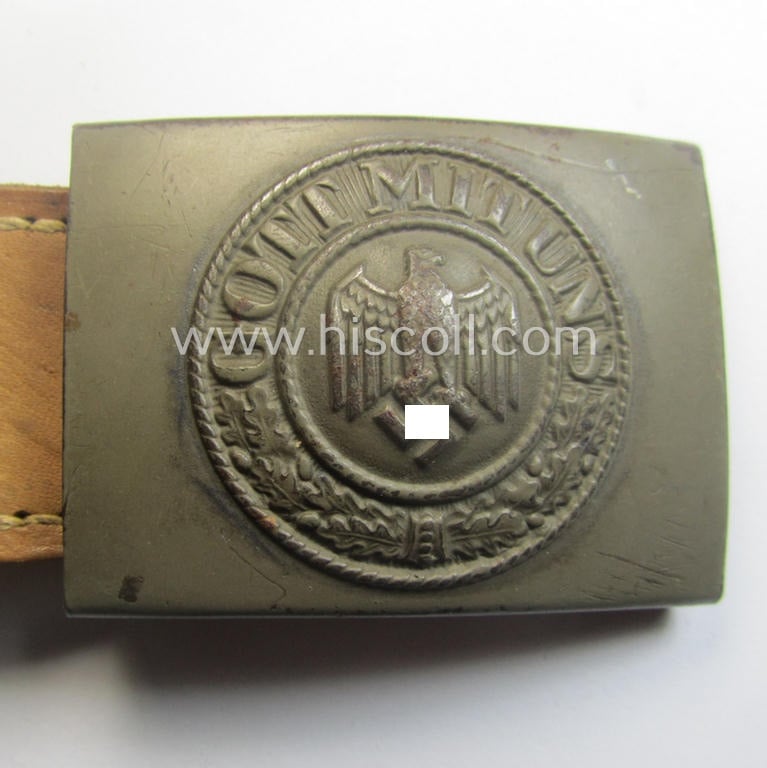 Minimally used, WH (Heeres) field-grey-coloured- and/or steel-based belt-buckle being a clearly maker-marked example that comes mounted onto its maker- (ie. 'E. Schneider - Lüdenscheid'-) marked and/or '1940'-dated leather-based tab