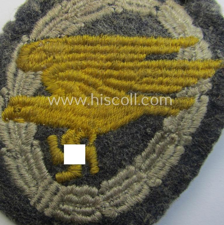 Truly worn WH (Luftwaffe) 'Fallschirmschützen-Abzeichen in Stoff' (or: cloth-based paratroopers' jump-badge) that is nicely machine-embroidered and being of the so-called: 'padded version'