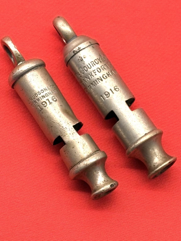 TWO AUTHENTIC ORIGINAL BRITISH OFFICERS WWI 1916 TRENCH WHISTLES AND LANYARD.
