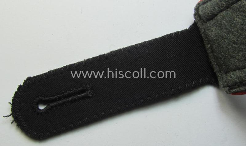 Single, Waffen-SS, NCO-type shoulderstrap as piped in the bright-red-coloured branchcolour as was intended for usage by an: 'SS-Unterscharführer' who served within the: 'SS-(Sturm)Artillerie-Trpn.'