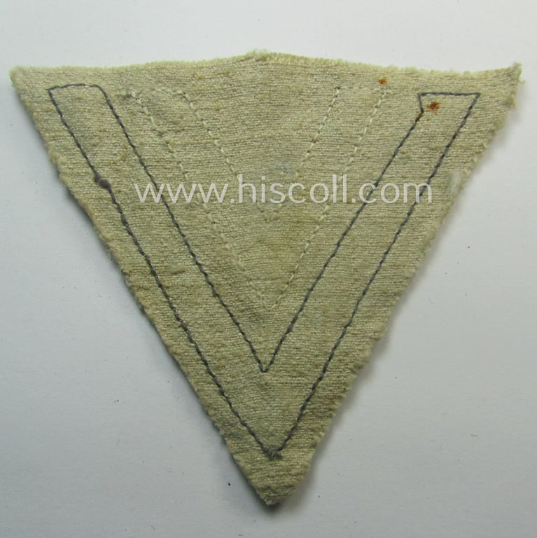 WH (Luftwaffe) 'Armwinkel' (or: arm-chevron) as executed on typical beige- (ie. tan-) coloured 'HBT'-styled linnen as was specifically intended for usage by a soldier with the rank of an: 'Obergefreiter'