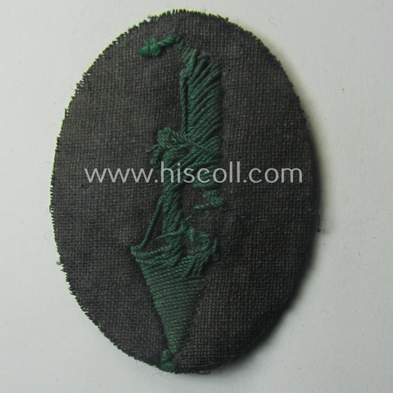 WH (Heeres) trade- and/or special-career-insignia ie. hand-embroidered 'signal-blitz' being a non-maker-marked example as executed in green-coloured linnen as was specifically intended for a soldier within the: 'Jäger- o. Geb.Jäger-Trpn.'