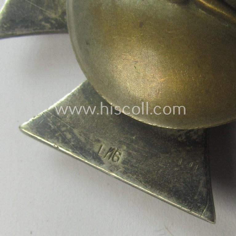 Moderately used, Iron Cross 1st class (or: 'Eisernes Kreuz 1. Klasse') as executed in the scarcely seen so-called: 'screw-back'- (ie. 'An der Schraube'-) pattern being a typical maker- (ie. 'L/16'-) marked example