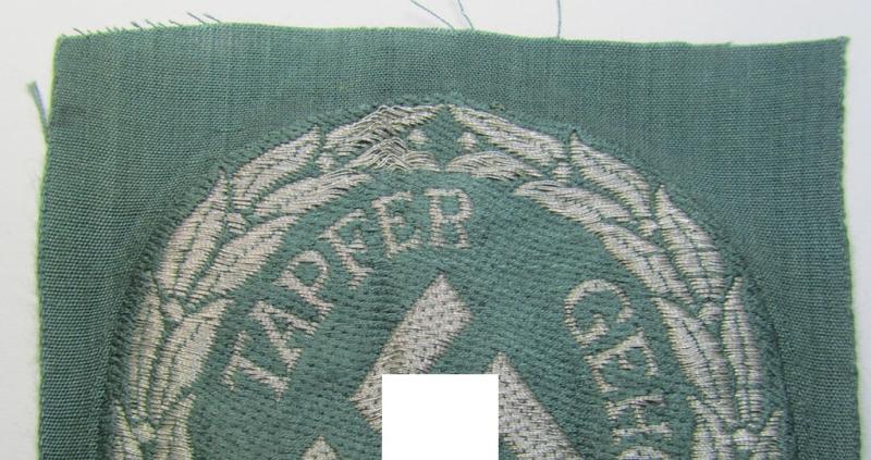 Superb - and actually rarely encountered! - officers'- (ie. evt. NCO-) type, so-called: 'Schutzmannschaften'- (ie. 'Schuma'-) armshield being executed in silver-grey-coloured 'flatwire'-thread onto a police-green-coloured background