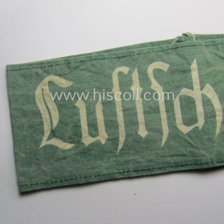 Clearly used - and most certainly not that often seen! - 'Reichsluftschutzbund' (ie. 'RLB'-) related service-armband (ie. 'Armbinde') being of the 'entirely printed'-type showing the text: 'Luftschutz'