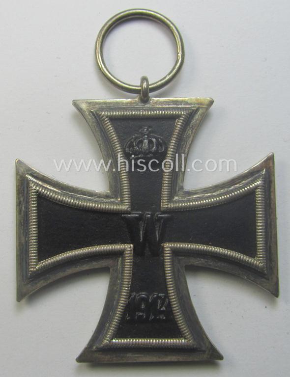 WWI-period: 'Eisernes Kreuz II. Klasse' (or: iron cross second class) being a maker- (ie. 'KO'-) marked example that comes together with its (minimally) confectioned piece of ribbon (ie. 'Bandabschnitt')