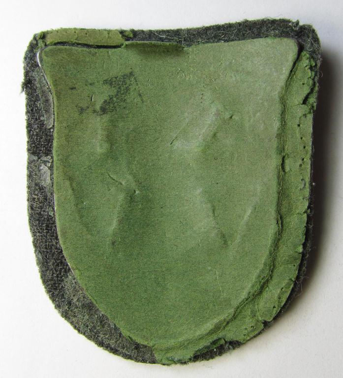 Attractive, WH (Heeres o. Waffen-SS) 'Krim'-campaign-shield that comes mounted onto its original, field-grey-coloured 'backing' and that comes in an issued-, minimally worn and/or carefully tunic-removed-, condition