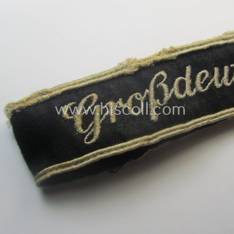 Truly used- and/or worn example of a WH (Heeres) cuff-title ie. armband (ie. 'Ärmelstreifen') entitled: 'Grossdeutschland' (being a neatly machine-embroidered example of the third pattern that was specifically intended for EM- ie. NCO-usage)