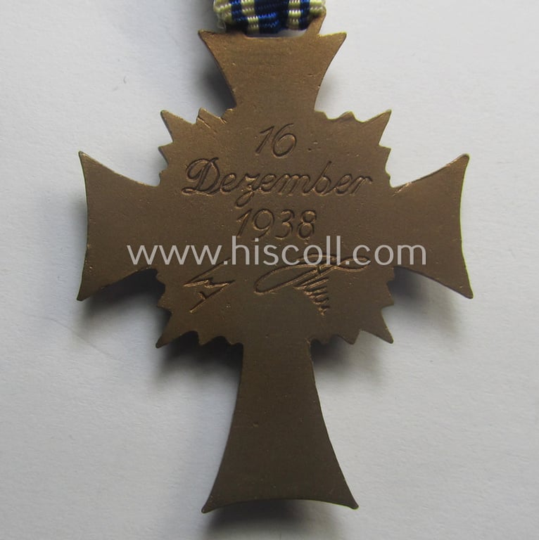 'Ehrenkreuz der deutschen Mutter - dritte Stufe' (or: bronze-class mothers'-cross) that came mounted onto its long-sized ribbon and that came stored in its period pouch by the maker: 'Donner Münzpräge - Wuppertal'