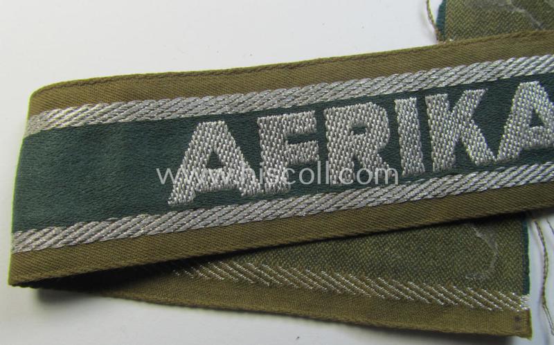 Attractive, 'BeVo'-like cuff-title (ie. 'Ärmelstreifen') entitled: 'Afrikakorps' being a with certainty issued and truly worn example that comes in an overall nice- (ie. minimally shortened- and/or once tunic-attached-), condition