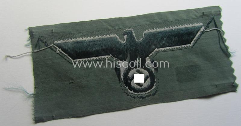 WH (Heeres) early-war-period- and/or greyish-coloured breast-eagle of the: 'M40'-pattern as was executed in the 'BeVo'-weave pattern on a darker-green-coloured background