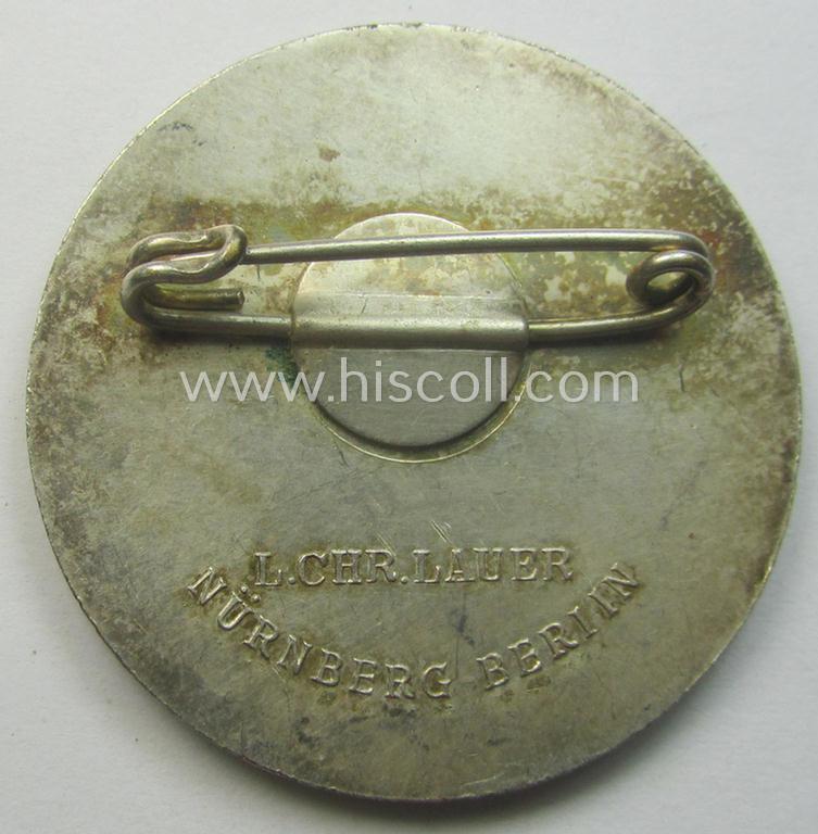 Commemorative, N.S.D.A.P.-related 'tinnie' or day-badge being a clearly maker- (ie. 'L.Chr. Lauer'-) marked example depicting detailed illlustration of 'Adolf Hitler' coupled with the text: 'Pasewalk - 21. Okt. 1937'