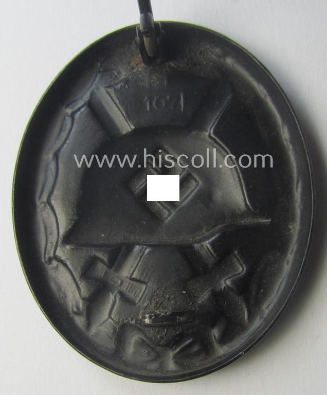 Nicely maker- (ie. '107-) marked example of a black-class wound-badge (or: 'Verwundeten-Abzeichen in Schwarz') being an example that was produced by the maker (ie. 'Hersteller') named: 'Carl Wild'