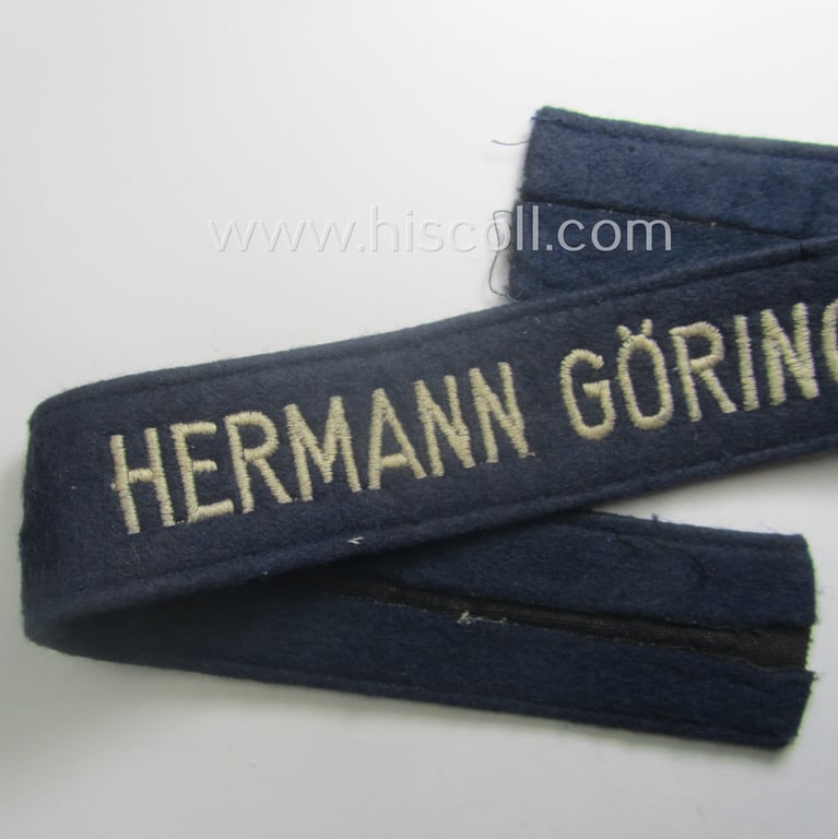 Truly used- and/or tunic-removed, typical 'smooth-woolen'-based, EM- (ie. NCO-) pattern WH (Luftwaffe) cuff-title (ie. 'Ärmelstreifen') entitled: 'Hermann Göring' that comes in that comes in an overall very nice condition
