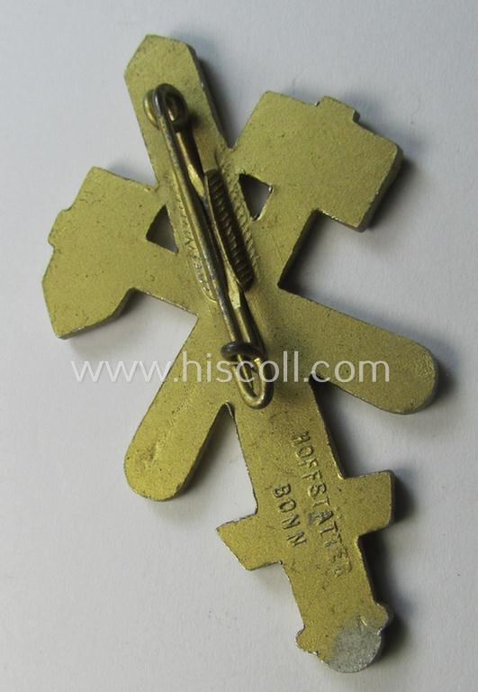 Commemorative, golden-coloured, N.S.D.A.P.-related 'tinnie' being a maker- (ie. 'Hofstätter - Bonn'-) marked example depicting a detailed, upright-positioned sword and two 'hammers' and swastika and bearing the dates: '1925 - 1935'