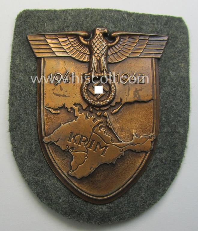 WH (Heeres ie. Waffen-SS) 'Krim'-campaign-shield (by the maker: 'Friedrich Orth') that comes stored in its period (and rarely seen!) 'Zellstoff'-based pouch and that comes in a probably issued- (albeit still 'virtually mint'-), condition