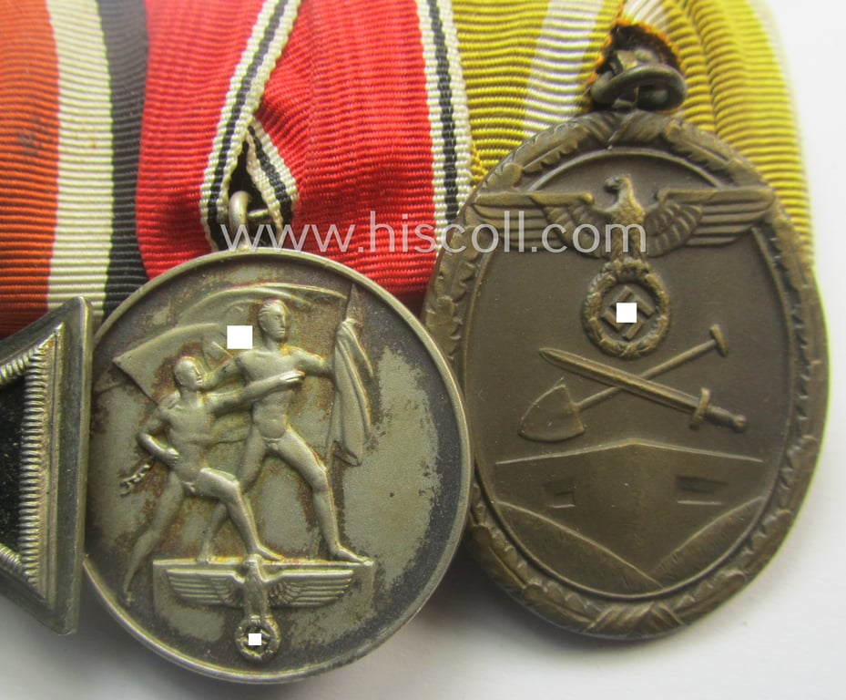 3-pieced, WWII- (ie. TR-) period medal-bar (ie. 'Ordenspange') showing resp. an: 'EKII.Kl.', an Austrian 'Anschluss'-medal '13. März 1938' and a: 'Westwall'-medal