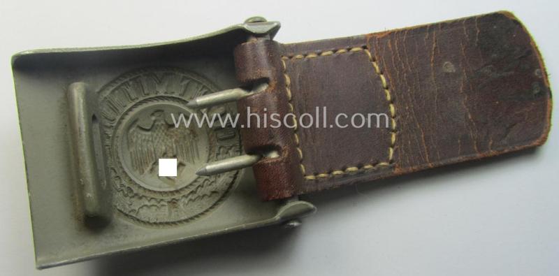 WH (Heeres) 'standard-pattern', field-grey-toned- and aluminium-based belt-buckle being a maker- (ie. 'E. Schneider - Lüdenscheid'-) marked- and/or: '1938'-dated example that comes mounted onto its leather-based tab