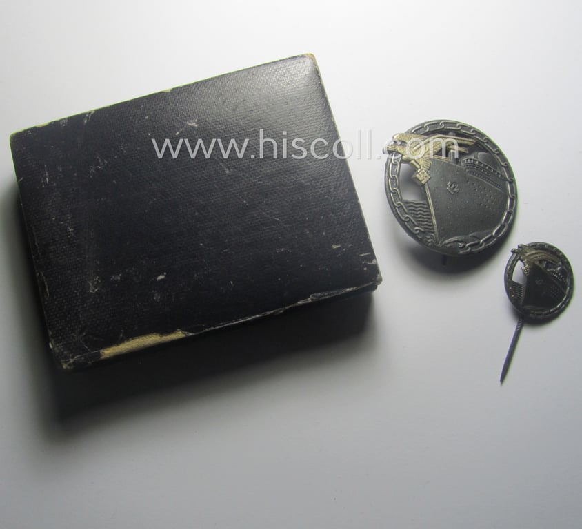 Attractive - and complete! - set comprising of a WH (KM) 'Blockadebrecher-Kriegsabzeichen' being a maker- (ie. 'Schwerin'-) marked example that comes together with its accompanying 'Halbminiatur' as stored in its (damaged- ie. relic) etui