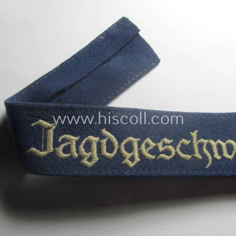 Moderately used, WH (Luftwaffe) cuff-title ie. armband (ie. 'Ärmelstreifen') entitled: 'Jagdgeschwader Udet' that comes in a clearly worn- ie. carefully tunic-removed-, condition