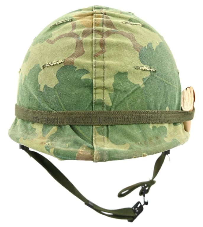 US Vietnam War Infantry helmet with camouflage cover and attached content