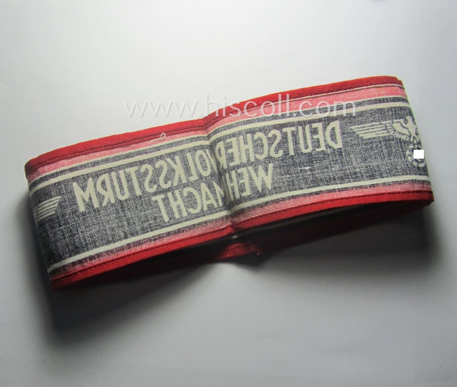 Typically printed- and/or later-war-period, bright-red- and/or black-coloured so-called: 'Deutscher Volkssturm'-armband (ie. 'Armbinde') that comes in an overall very nice- (I deem hardly used- nor worn- ie. 'virtually mint'-), condition