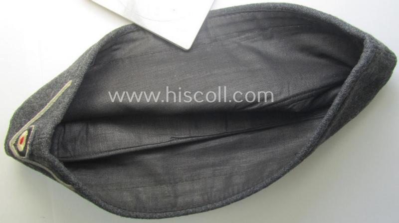 Darker-greyish-blue-coloured, so-called: German Red Cross (ie. 'Deutsches Rotes Kreuz' or: 'DRK' EM- (ie. NCO-) type side-cap (ie. 'Schiffchenmütze für Mannschaften u. Uffz. des deutschen Rotes Kreuzes')